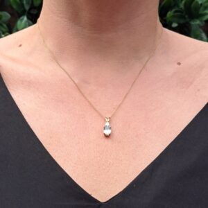 9ktYellow Gold Oval Sky Blue topaz and diamond pendant