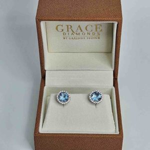 9kt White Gold Earrings with 6x6mm Round Cut London Blue Topaz and 0.20ct H Colour SI Clarity Round Brilliant Cut Diamond Halo