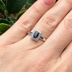 9kt White Gold Ring with Emerald Cut Blue Sapphire and Diamond Halo
