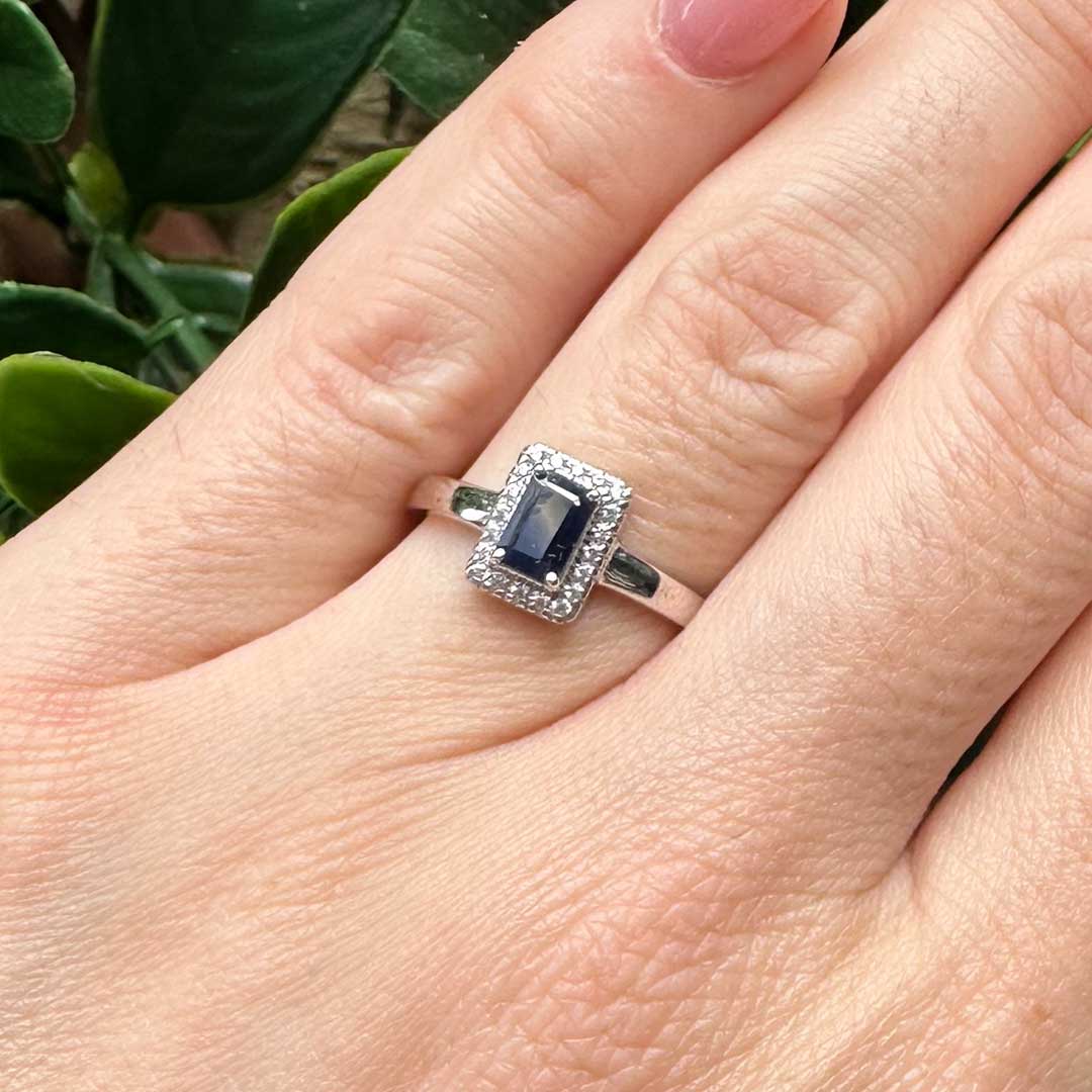 9kt White Gold Ring with Emerald Cut Blue Sapphire and Diamond Halo