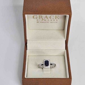 9kt White Gold Ring with Emerald Cut Blue Sapphire and Diamond Halo