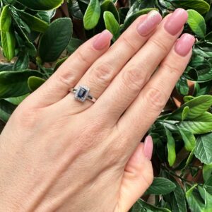 9kt White Gold Ring with Emerald Cut Blue Sapphire and Diamond Halo