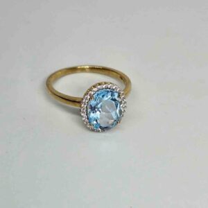 9kt Yellow Gold Ring with Oval Cut Sky Blue Topaz and Round Brilliant Cut Diamonds