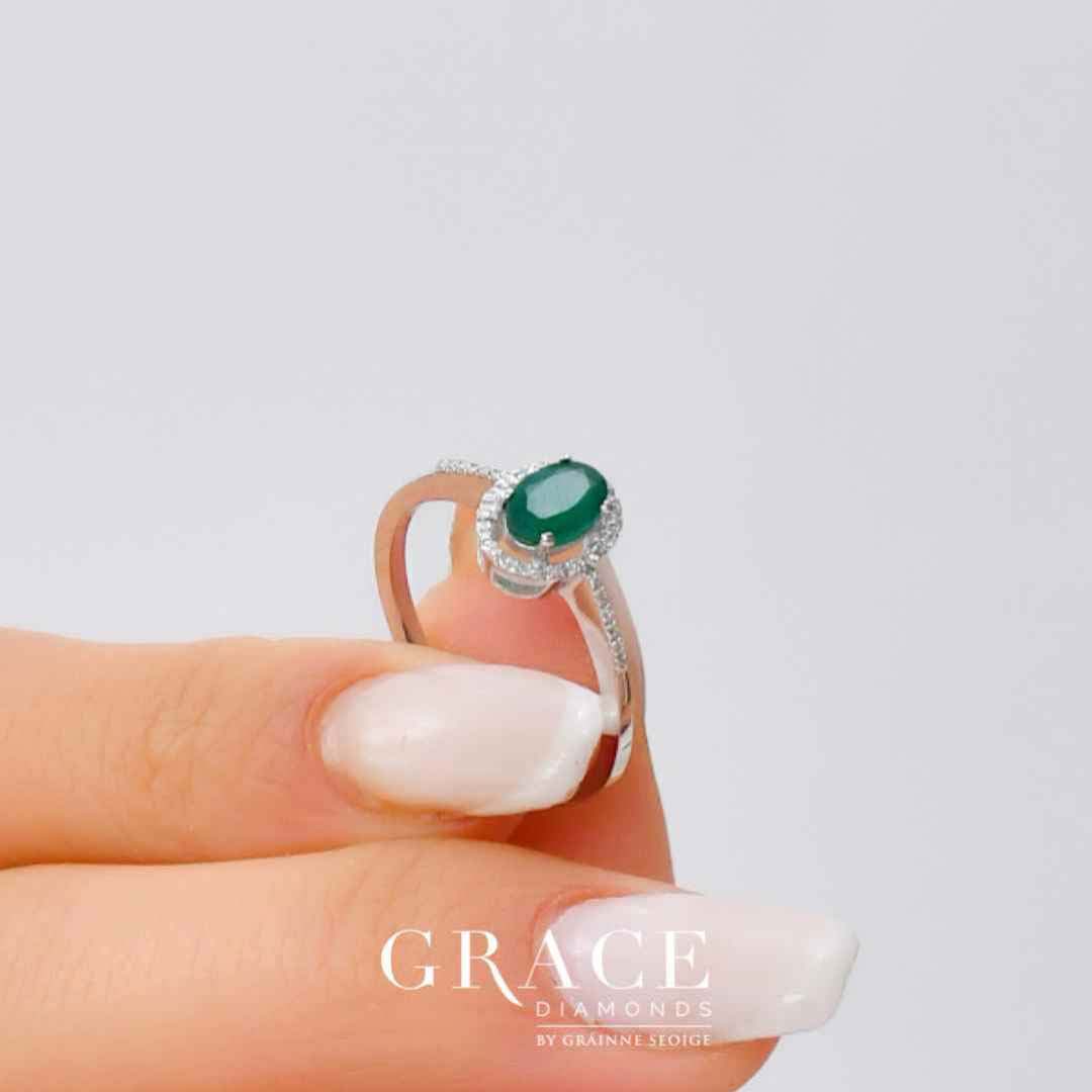 18kt White Gold Ring with Oval Cut Emerald and Diamond Halo