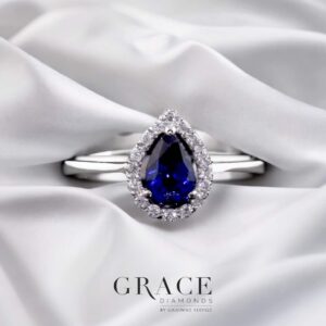 18kt White Gold Ring with 6x4mm Pear Cut Blue Sapphire and Round Brilliant Cut Diamond Halo